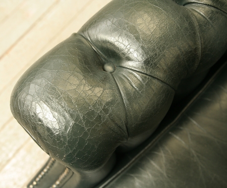 Pair Of Dark Green Leather Wing Chairs 